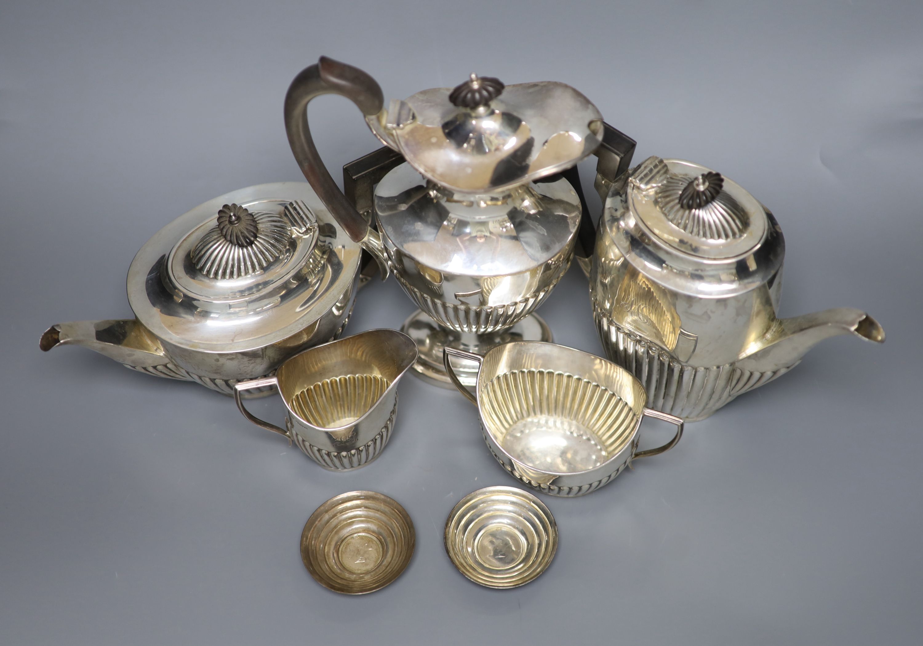 A George V demi fluted silver four piece tea and coffee service, Mappin & Webb, Sheffield, 1912, a matched plated hot water pot and two small 925 dishes